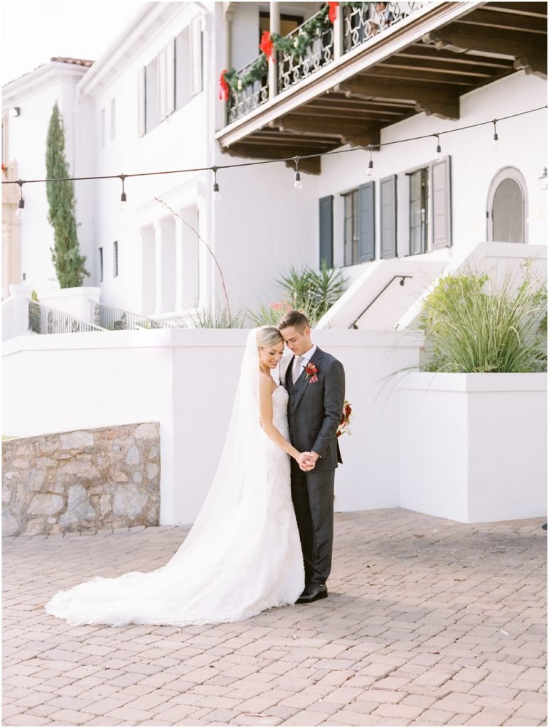 Bride and groom embracing outside Wrigley Mansion wedding venue in Phoenix