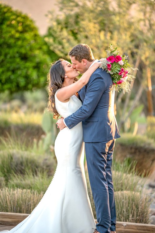 Bride and groom kissing during sunset wedding portraits at Andaz Scottsdale Resort