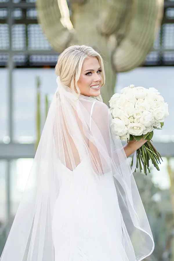 Bride smiling in her wedding gown at a luxury Scottsdale desert wedding<br />
