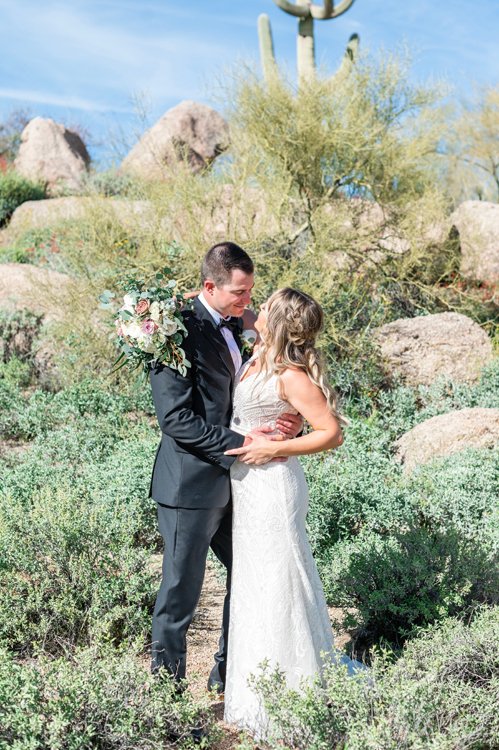 Phoenix wedding photographer capturing a bride and groom embracing in the Arizona desert.