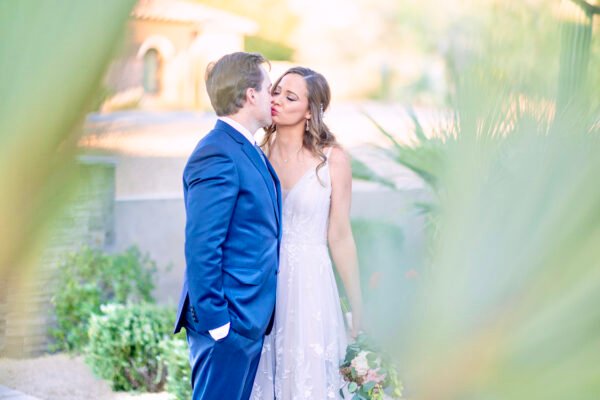 Groom and bride holding each other outdoors