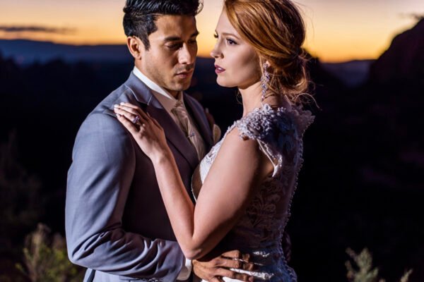 Stylized dramatic portrait of couple in dark studio light