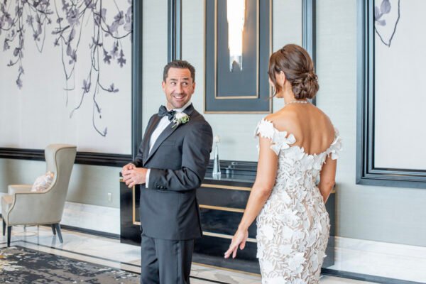 Bride and groom posed indoors in elegant venue