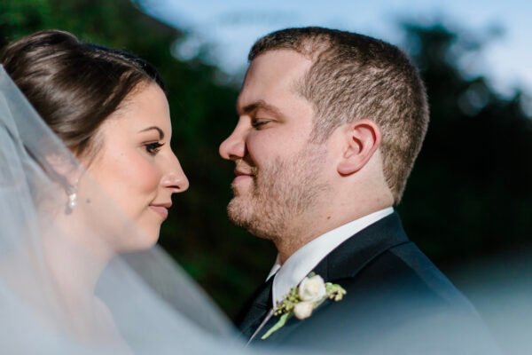 Bride and groom touching foreheads affectionately